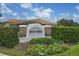 The River Place neighborhood entrance features brick columns, lush landscaping, and a decorative sign at 7119 67Th E Ter, Bradenton, FL 34203