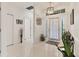 Bright entry foyer with tile flooring, transom window, and modern lighting fixture at 7119 67Th E Ter, Bradenton, FL 34203