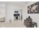 Hallway with modern decor, including a wine barrel table and view of an office area at 7119 67Th E Ter, Bradenton, FL 34203