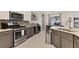 Modern kitchen with stainless steel appliances, bar and game room access, perfect for entertaining guests at 7119 67Th E Ter, Bradenton, FL 34203