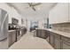 Spacious kitchen with gray cabinets and bar area, seamlessly flowing into game room for entertainment at 7119 67Th E Ter, Bradenton, FL 34203
