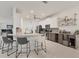 Stylish kitchen featuring a functional island, white cabinetry, and a sleek bar area for entertaining at 7119 67Th E Ter, Bradenton, FL 34203