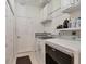 Clean laundry room with a washer, dryer, storage cabinets, and access door at 7119 67Th E Ter, Bradenton, FL 34203