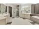 Luxurious main bathroom featuring a glass shower, soaking tub, and dual vanities at 7119 67Th E Ter, Bradenton, FL 34203