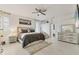 Spacious main bedroom featuring neutral tones, a ceiling fan, and a walk-in closet at 7119 67Th E Ter, Bradenton, FL 34203