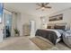 Well-lit main bedroom with a sliding glass door to the outside, a ceiling fan and ensuite bath at 7119 67Th E Ter, Bradenton, FL 34203