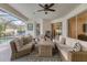 Outdoor living area with sofas, chairs, firepit, and pool at 7119 67Th E Ter, Bradenton, FL 34203