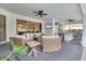 Inviting covered patio boasts comfortable seating, ceiling fans, and outdoor bar area with television at 7119 67Th E Ter, Bradenton, FL 34203