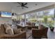 Inviting outdoor living space with comfortable seating, a fan, and a view of the pool at 7119 67Th E Ter, Bradenton, FL 34203
