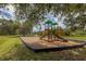 Community playground featuring colorful climbing structures, slides, and swings in a grassy park setting at 7119 67Th E Ter, Bradenton, FL 34203