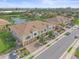 Aerial view of multi-Gathering homes showcasing well-manicured landscaping, a tranquil lake, and convenient parking at 7325 Skybird Rd # 399, Bradenton, FL 34209