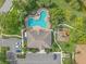 Aerial view of the community pool, playground, clubhouse, parking and landscaping at 7325 Skybird Rd # 399, Bradenton, FL 34209