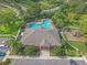 Overhead shot of the pool, playground, clubhouse and parking surrounded by mature trees at 7325 Skybird Rd # 399, Bradenton, FL 34209