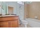 Bathroom with a vanity, mirror, toilet, and a tub-shower combo with tile surround at 7325 Skybird Rd # 399, Bradenton, FL 34209