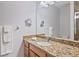 Clean bathroom features a modern vanity with granite countertops, sleek faucet, and a well-lit mirror at 7325 Skybird Rd # 399, Bradenton, FL 34209
