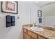 Bathroom vanity area features granite countertops, a modern faucet, neutral wall art, and decorative towels at 7325 Skybird Rd # 399, Bradenton, FL 34209