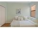Comfortable bedroom with a trundle bed, pale green walls, a window, and minimalist décor at 7325 Skybird Rd # 399, Bradenton, FL 34209