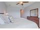 Bright bedroom with a comfortable bed, wooden floors, ceiling fan, a wooden dresser and decor at 7325 Skybird Rd # 399, Bradenton, FL 34209