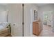 Inviting hallway leading to a bright room, with a chest of drawers, artwork, and neutral walls at 7325 Skybird Rd # 399, Bradenton, FL 34209