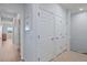 Bright hallway featuring clean white doors, neutral walls, and tiled flooring leading to sunlit living spaces at 7325 Skybird Rd # 399, Bradenton, FL 34209