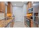 Functional kitchen featuring granite countertops, wooden cabinets, stainless steel appliances, and modern fixtures at 7325 Skybird Rd # 399, Bradenton, FL 34209