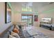 Stylish living room with gray couch, glossy ceilings, and stunning lake view from the sliding doors at 7325 Skybird Rd # 399, Bradenton, FL 34209