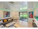 Cozy living room boasting a gray couch, glossy ceiling, artwork, and large window view at 7325 Skybird Rd # 399, Bradenton, FL 34209