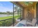 Relaxing screened patio with comfortable seating, ceiling fan, and serene water views at 7325 Skybird Rd # 399, Bradenton, FL 34209