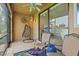Outdoor patio with comfortable seating, ceiling fan, and sliding glass doors leading to the interior living space at 7325 Skybird Rd # 399, Bradenton, FL 34209