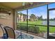 Enclosed patio features scenic views of the pond, manicured lawns, and neighboring buildings at 7325 Skybird Rd # 399, Bradenton, FL 34209