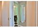 Bathroom doorway shows updated space with checkered floor and vintage vanity at 7355 Cass Cir, Sarasota, FL 34231