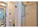 Bathroom with tiled shower, checkerboard floors, and adjacent room at 7355 Cass Cir, Sarasota, FL 34231