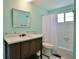 Bathroom featuring a modern vanity, mirror, and shower/tub with white tile surround at 7355 Cass Cir, Sarasota, FL 34231