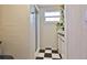 Bathroom features tiled shower and checkerboard tile floors at 7355 Cass Cir, Sarasota, FL 34231