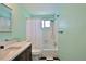 Bright bathroom featuring mint walls, a shower/tub combo, and checkerboard tile floors at 7355 Cass Cir, Sarasota, FL 34231