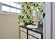 Bright bathroom features lively wallpaper, granite countertop, and white vanity at 7355 Cass Cir, Sarasota, FL 34231