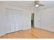 Neutral bedroom featuring hardwood floors, a closet, and doorway at 7355 Cass Cir, Sarasota, FL 34231