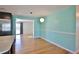 Bright dining area featuring hardwood floors, calming paint and a modern light fixture at 7355 Cass Cir, Sarasota, FL 34231