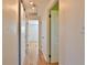 Hallway featuring hard wood floors, paneled doors and overhead track lighting at 7355 Cass Cir, Sarasota, FL 34231
