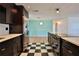 Modern kitchen featuring stainless steel appliances, quartz countertops, and stylish black-and-white checkered flooring at 7355 Cass Cir, Sarasota, FL 34231