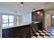 Updated kitchen featuring an oven, quartz countertops, a black and white tile floor, and breakfast bar at 7355 Cass Cir, Sarasota, FL 34231