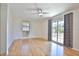 Living room features wood floors, large windows, and slider to exterior at 7355 Cass Cir, Sarasota, FL 34231