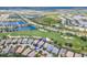 Aerial view of a home circled in blue, near a golf course, a lake, and a road at 7542 Windy Hill Cv, Bradenton, FL 34202