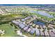 Aerial view of a home circled in blue, overlooking a lush golf course and a serene lake at 7542 Windy Hill Cv, Bradenton, FL 34202