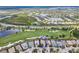 Aerial view of a home circled in blue, situated on a well-manicured property near a golf course and lakes at 7542 Windy Hill Cv, Bradenton, FL 34202