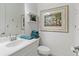 Bathroom featuring a white vanity, commode, and framed mermaid art at 7542 Windy Hill Cv, Bradenton, FL 34202