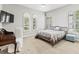 Bedroom with plantation shutters, a ceiling fan, and ample sunlight at 7542 Windy Hill Cv, Bradenton, FL 34202