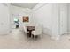 Traditional dining room featuring neutral tones, tile floors, and a modern chandelier at 7542 Windy Hill Cv, Bradenton, FL 34202