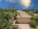 Beautiful single-Gathering home with a manicured lawn, a tile roof, and a brick driveway leading to a two-car garage at 7542 Windy Hill Cv, Bradenton, FL 34202