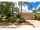 Inviting single-Gathering home featuring manicured landscaping, a tile roof, and a two-car garage at 7542 Windy Hill Cv, Bradenton, FL 34202